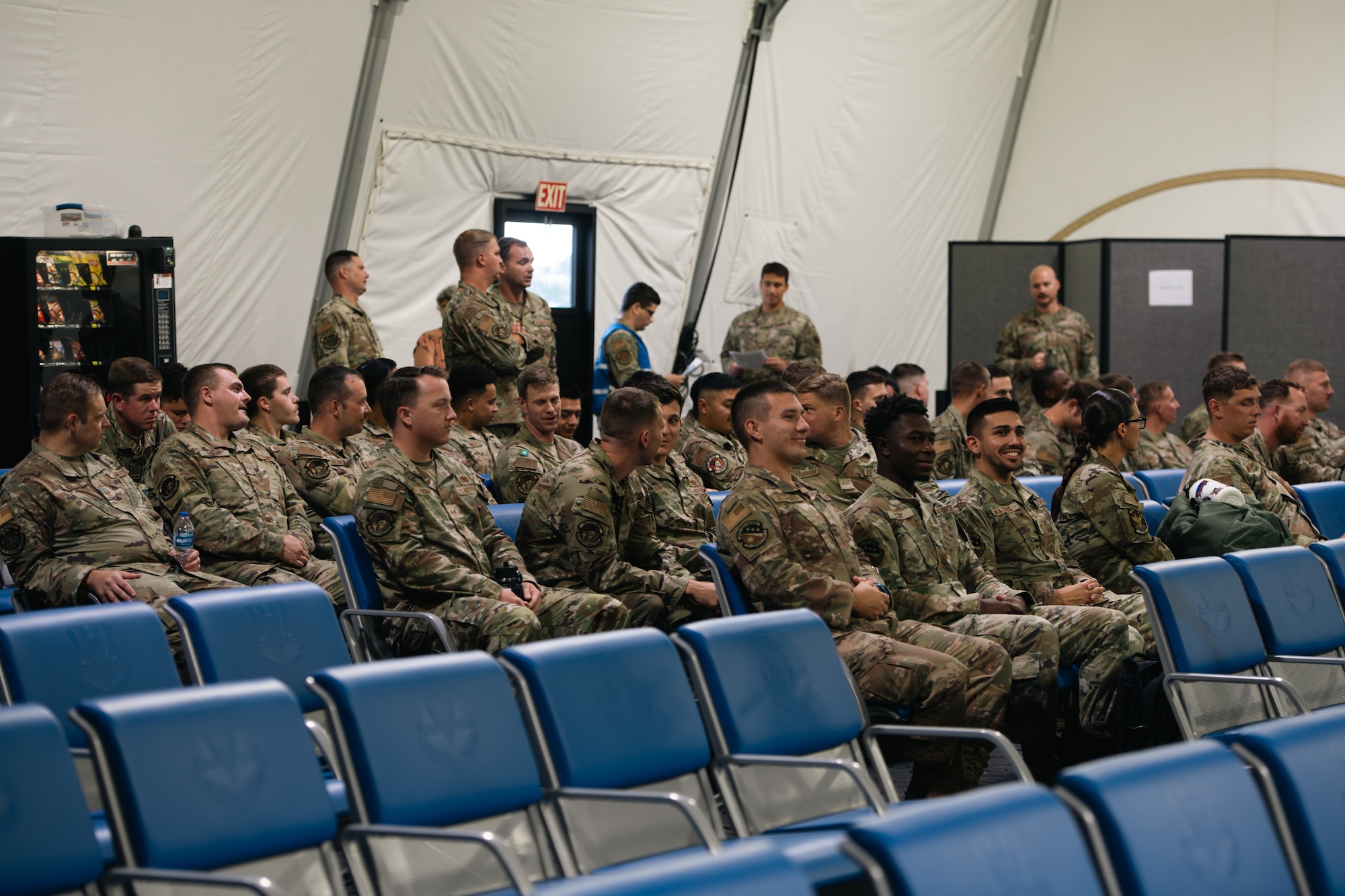 Airmen listen to predeployment briefings.