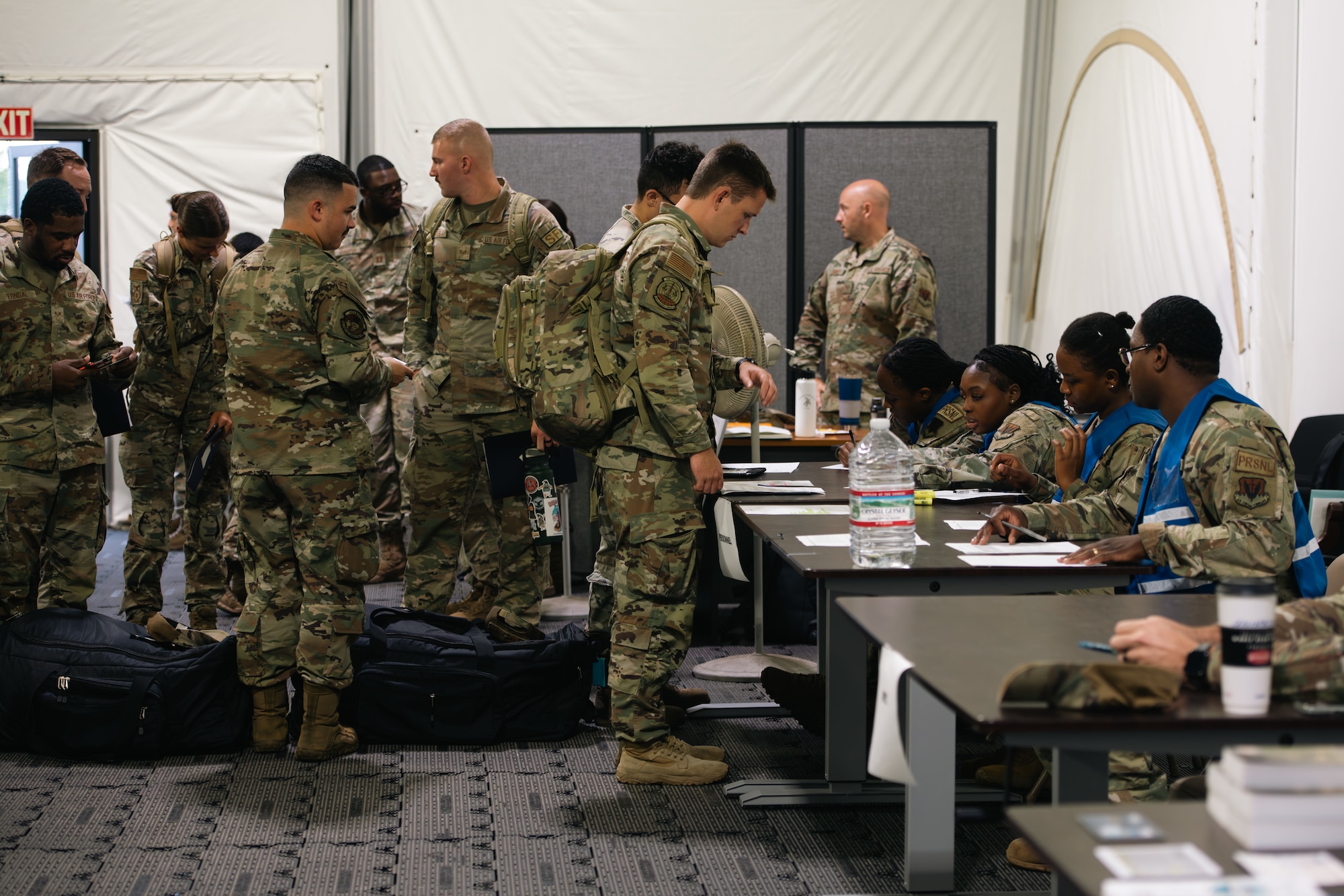 Airmen go through a predeployment checklist line.