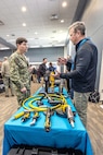 Capt. JD Crinklaw, commander, Puget Sound Naval Shipyard & Intermediate Maintenance Facility, receives a hands-on demonstration of pneumatic and electric equipment from Joe Rarick, of Atlas Copco, Sept. 28, 2023, during the PSNS & IMF Technology Showcase at the Kitsap Conference Center in Bremerton, Washington.