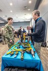 Capt. JD Crinklaw, commander, Puget Sound Naval Shipyard & Intermediate Maintenance Facility, receives a hands-on demonstration of pneumatic and electric equipment from Joe Rarick, of Atlas Copco, Sept. 28, 2023, during the PSNS & IMF Technology Showcase at the Kitsap Conference Center in Bremerton, Washington.