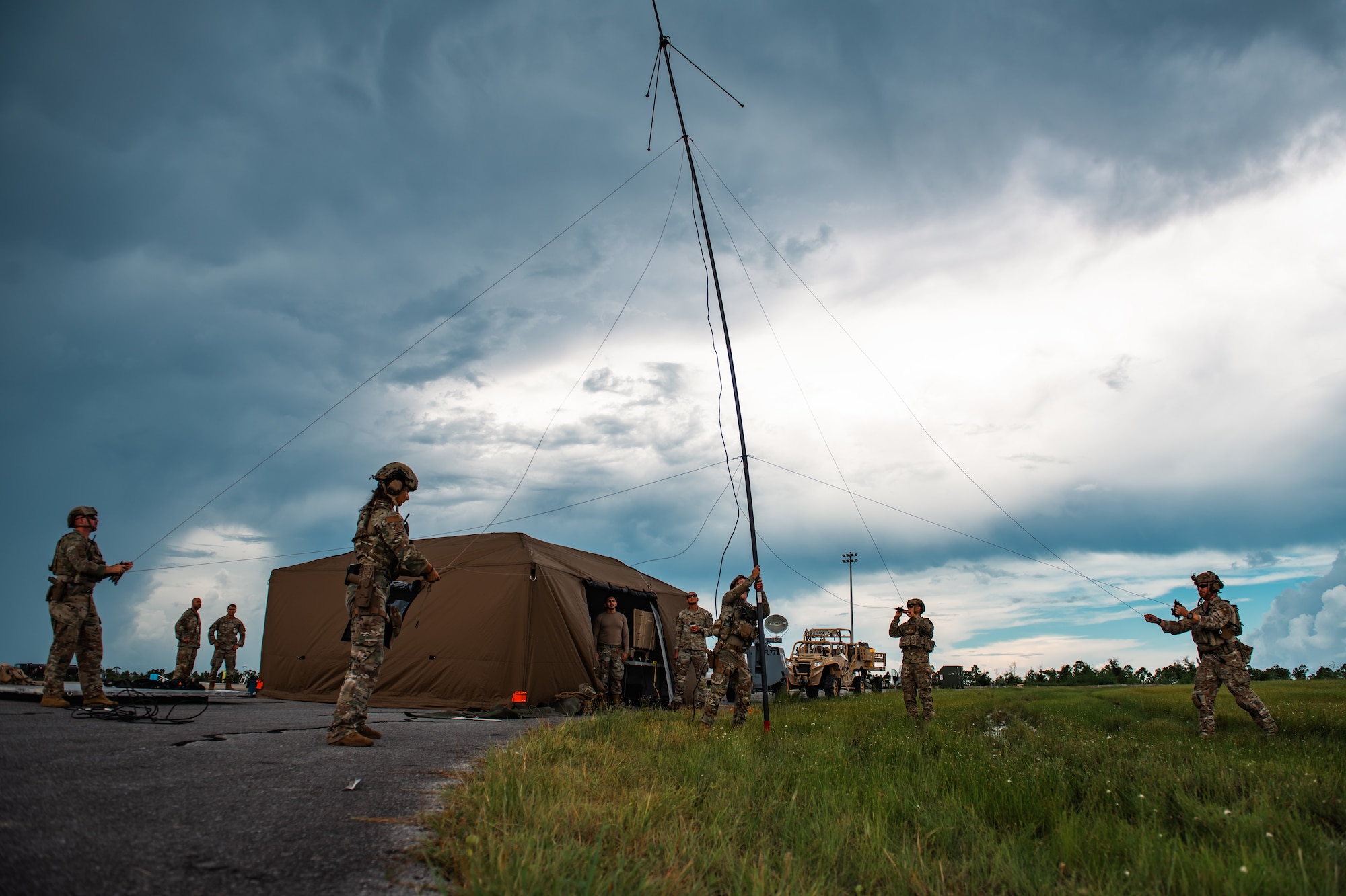 Airmen set up a radio antenna.