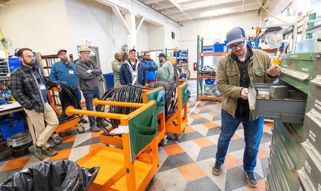 Bryan Weable, electrical supervisor, Shop 51, Electricians, leads
a tour of Building 427, May 21, 2024, at Puget Sound Naval Shipyard & Intermediate Maintenance Facility in Bremerton, Washington, as part of the 2024 Electrical Community of Practice conference. (U.S. Navy photo by Wendy Hallmark)