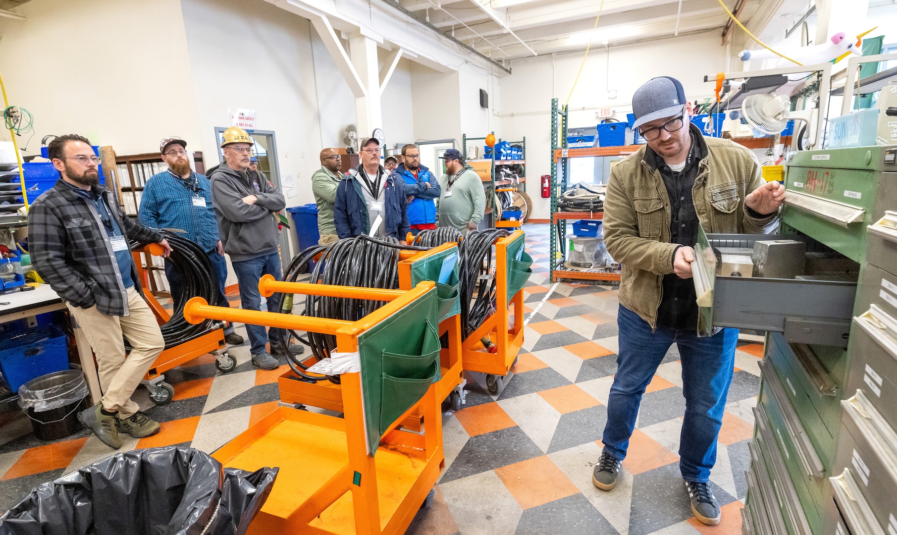 Bryan Weable, electrical supervisor, Shop 51, Electricians, leads
a tour of Building 427, May 21, 2024, at Puget Sound Naval Shipyard & Intermediate Maintenance Facility in Bremerton, Washington, as part of the 2024 Electrical Community of Practice conference. (U.S. Navy photo by Wendy Hallmark)