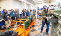 Bryan Weable, electrical supervisor, Shop 51, Electricians, leads
a tour of Building 427, May 21, 2024, at Puget Sound Naval Shipyard & Intermediate Maintenance Facility in Bremerton, Washington, as part of the 2024 Electrical Community of Practice conference. (U.S. Navy photo by Wendy Hallmark)