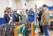 Bryan Weable, right, electrical supervisor, and Andy Allen, operations director, Shop 51, Electricians, lead a tour of Building 427 for ECOP members May 21, 2024, at Puget Sound Naval Shipyard & Intermediate Maintenance Facility in Bremerton, Washington. (U.S. Navy photo by Wendy Hallmark)