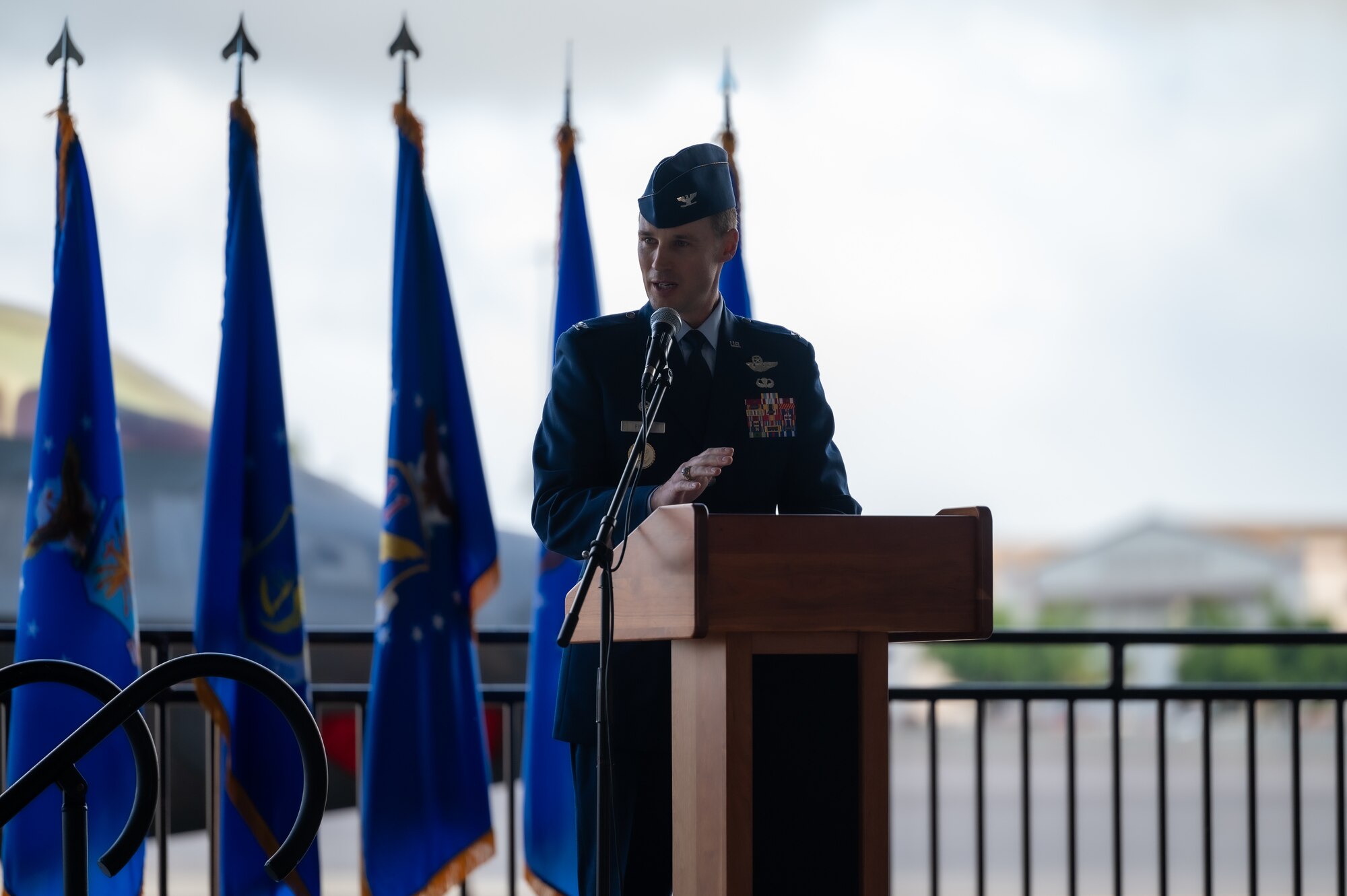 Airman speaks at a podium.