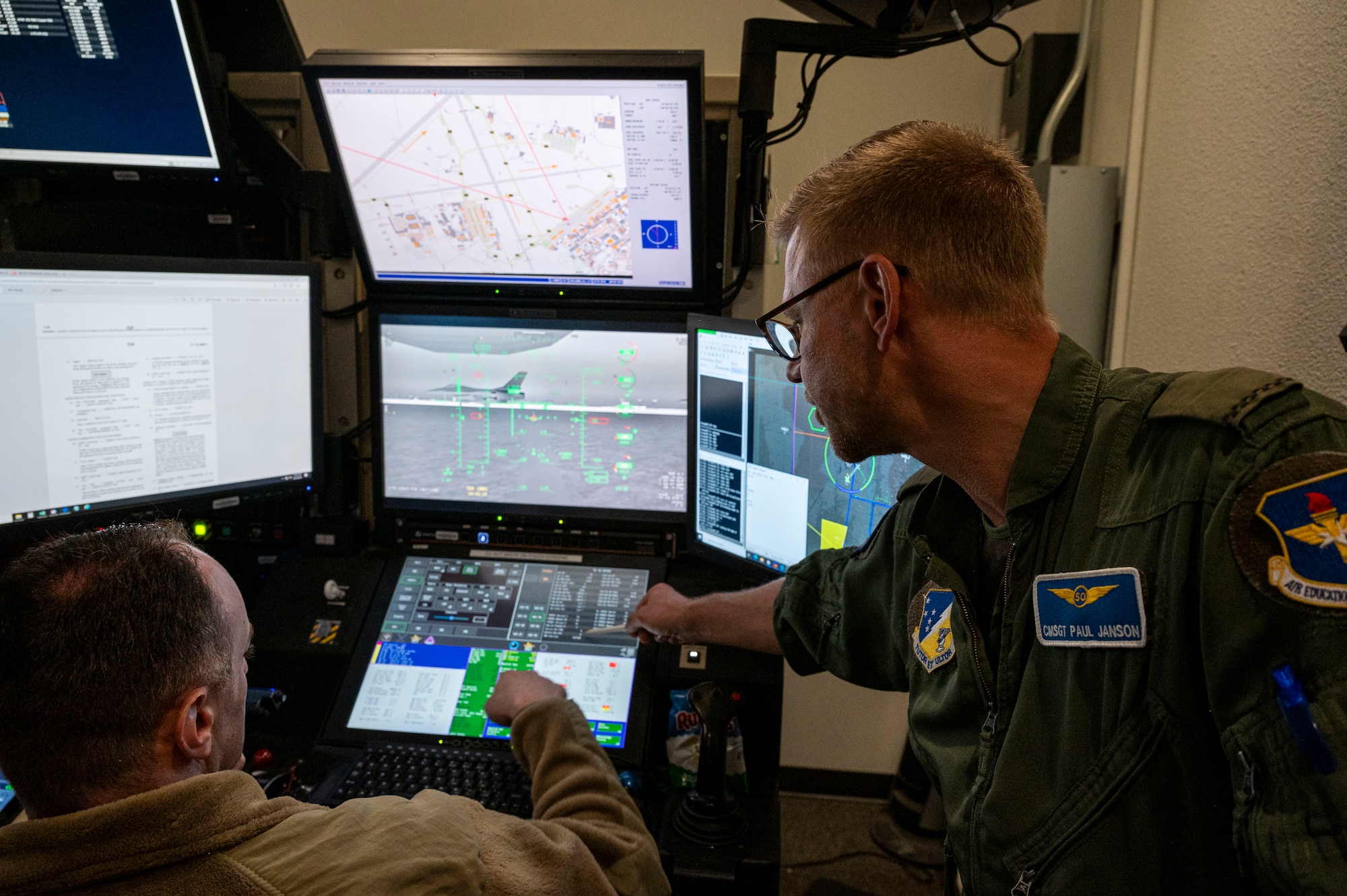 U.S. Air Force Master Sgt. Ryan Snyder, 16th Training Squadron plans and requirements superintendent, left, rates the instructing capabilities of Royal Netherlands Air Force Chief Master Sgt. Paulus Janson, 6th Attack Squadron sensor operator instructor at Holloman Air Force Base, New Mexico, June 25, 2024. The purpose of this collaboration is for the 49th Wing to assist train MQ-9 Reaper pilots and sensor operators from the U.S. and allied nations, fostering international cooperation and ensuring consistent training standards for future NATO operations. (U.S. Air Force photo by Senior Airman Isaiah Pedrazzini)