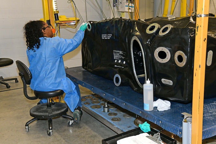 Women working on an aircraft fuel bladder