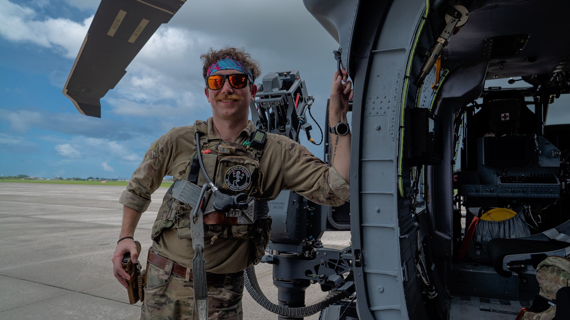 U.S. Air Force Staff Sgt. Cody Usher, 33rd Rescue Squadron special missions aviator, takes a break after performing preflight inspections on an HH-60W Jolly Green II at Kadena Air Base, Japan, July 17, 2024. The 33rd RQS conducts extensive training in various rescue scenarios to ensure they are ready to effectively respond to real-world contingencies. (U.S. Air Force photo by Senior Airman Cedrique Oldaker)