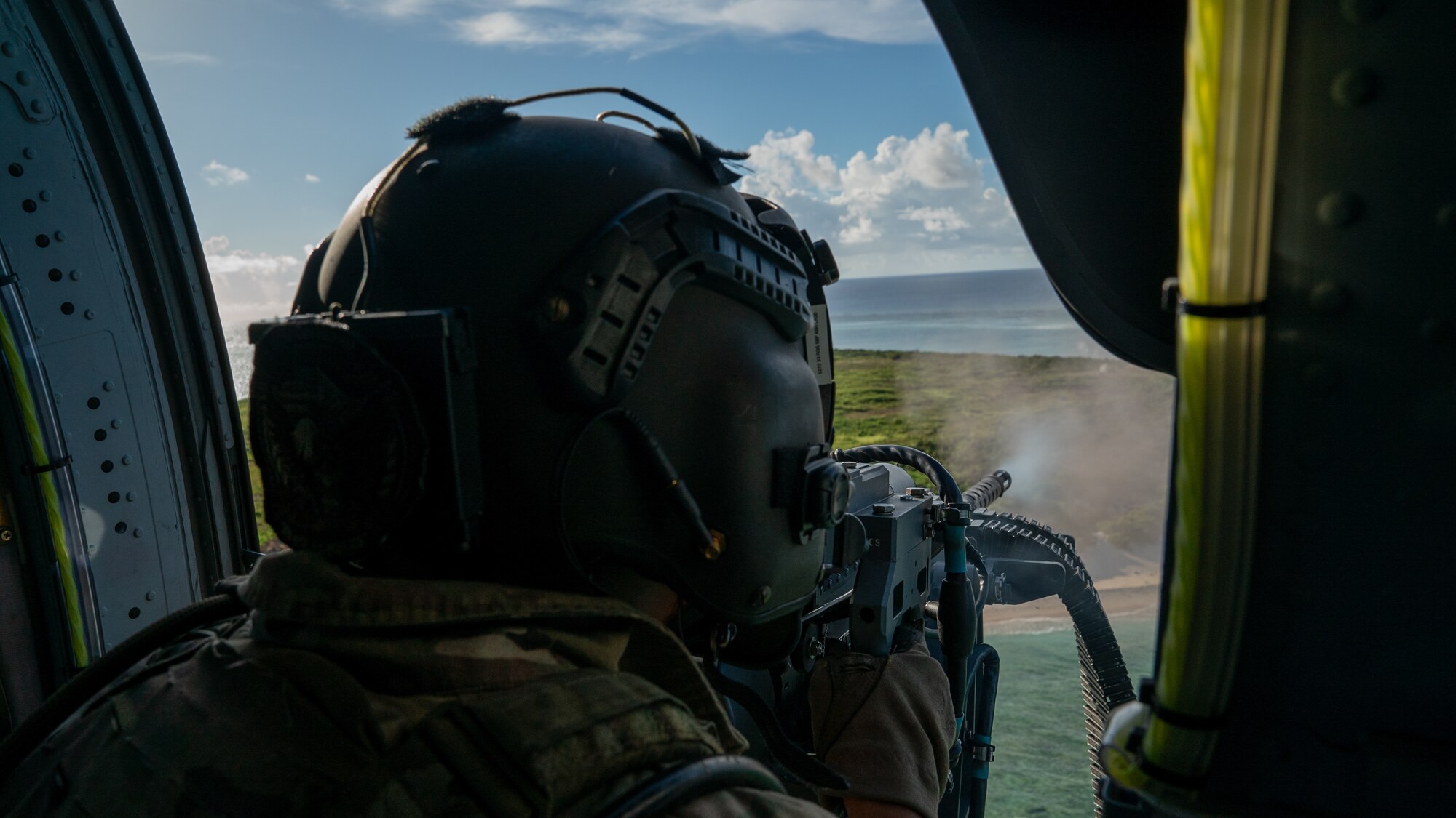 A U.S. Air Force special missions aviator with the 33rd Rescue Squadron operates a GAU-21 weapon system on an HH-60W Jolly Green II during routine training over the Pacific Ocean, July 17, 2024. The 33rd RQS conducts extensive training in various rescue scenarios to ensure they are ready to effectively respond to real-world contingencies. (U.S. Air Force photo by Senior Airman Cedrique Oldaker)