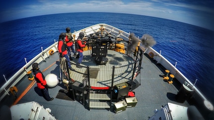 A crewmember aboard the Coast Guard Cutter Active, a 210-foot medium-endurance cutter homeported in Port Angeles, Wash., fires a 25mm gun during underway training, Sept. 10, 2016.