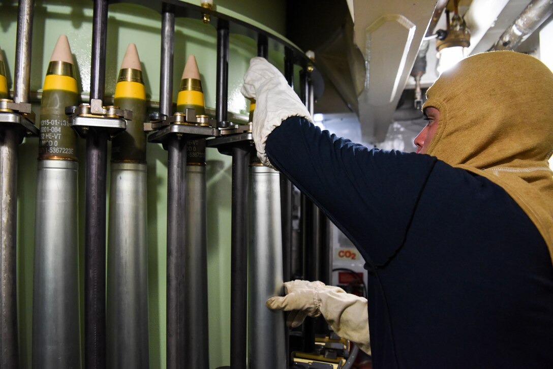 U.S. Coast Guard Seaman Santiago Jauregui, assigned to USCGC Mohawk (WMEC 913), loads 76mm rounds into the MK-75 gun while underway in the Atlantic Ocean, Sept. 9, 2022.