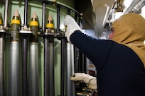 U.S. Coast Guard Seaman Santiago Jauregui, assigned to USCGC Mohawk (WMEC 913), loads 76mm rounds into the MK-75 gun while underway in the Atlantic Ocean, Sept. 9, 2022.