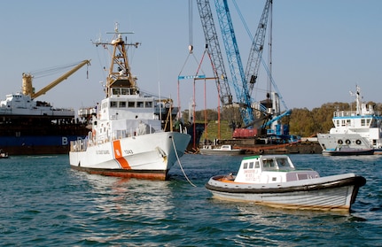 The U.S. Coast Guard Cutter Bainbridge Island (WPB 1343) is towed to the fuel pier after being offloaded from the motor vessel BBC Spain.