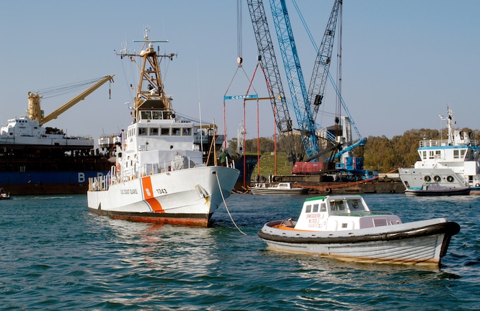 The U.S. Coast Guard Cutter Bainbridge Island (WPB 1343) is towed to the fuel pier after being offloaded from the motor vessel BBC Spain.