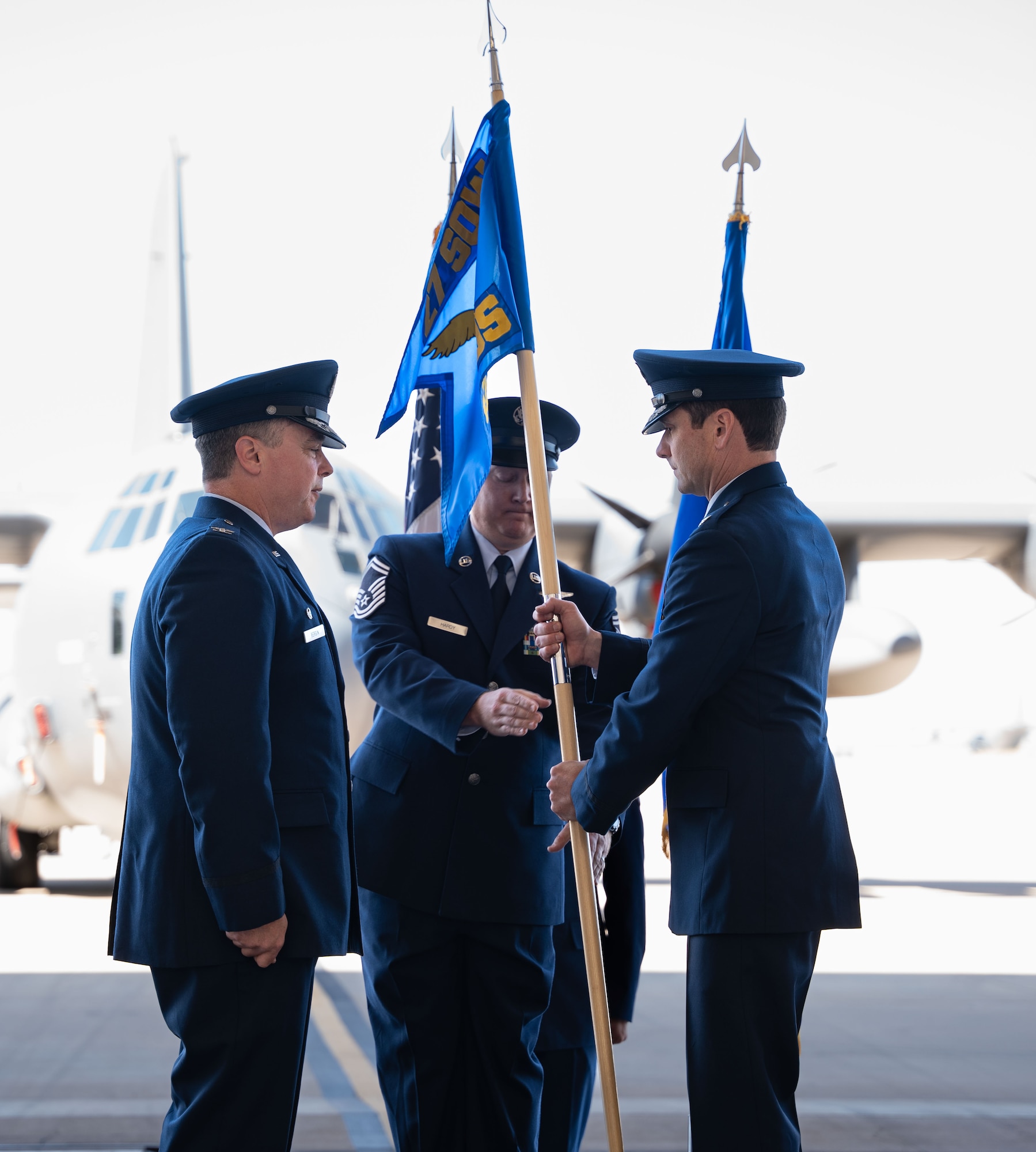 U.S. Air Force Lt. Col. Christoffer Tidwell (right) takes the guidon from Col. Jeremy Bergin, 27th Special Operations Wing commander, during the 6th Special Operations Squadron realignment ceremony, July 9, 2024, at Cannon Air Force Base, New Mexico.