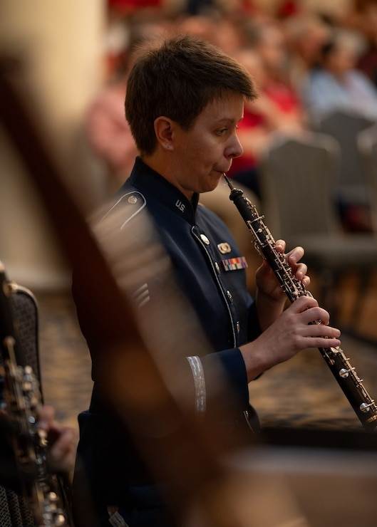 Air force oboist performs at a change of command.