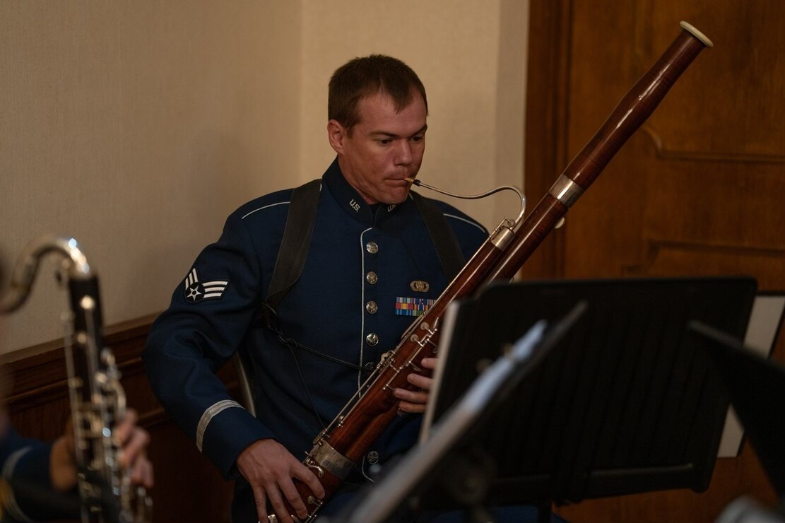 Air force bassoonist performs at a change of command.