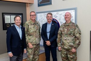 Four men standing next to each other for a group photo