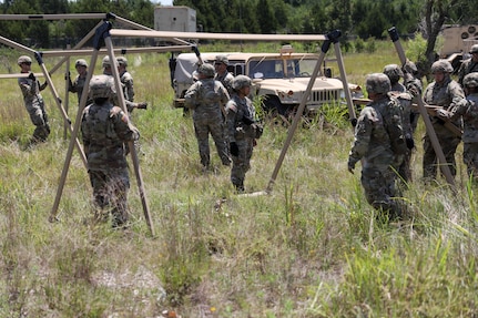 Oklahoma Army National Guard Soldiers from Headquarters Company, 700th Brigade Support Battalion, set up a tent as a part of the brigade support area at Glenwood Training Area in Midwest City, Oklahoma, July 13, 2024. The 700th BSB manages and supplies all the 45th Infantry Brigade Combat Team’s maneuver battalions and their forward support companies with all of their commodities, including food, water, fuel, ammunition, parts, and maintenance. (Oklahoma National Guard photo by Sgt. Connor McBride)