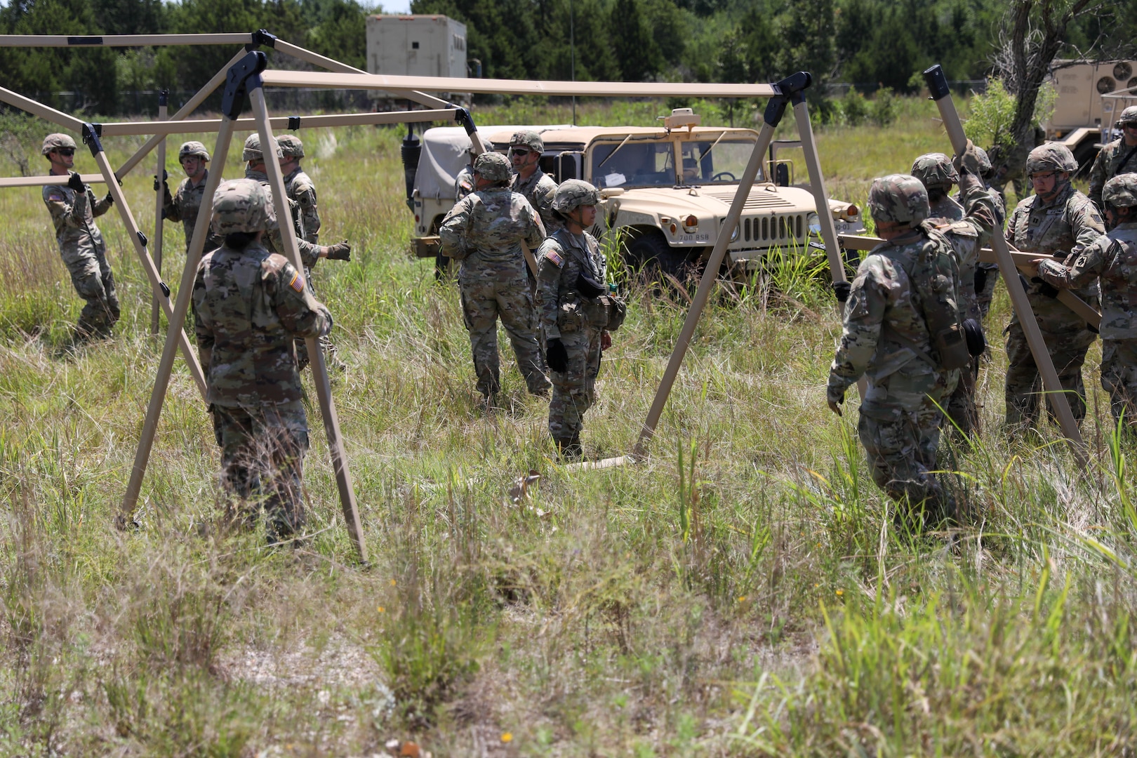 Oklahoma Army National Guard Soldiers from Headquarters Company, 700th Brigade Support Battalion, set up a tent as a part of the brigade support area at Glenwood Training Area in Midwest City, Oklahoma, July 13, 2024. The 700th BSB manages and supplies all the 45th Infantry Brigade Combat Team’s maneuver battalions and their forward support companies with all of their commodities, including food, water, fuel, ammunition, parts, and maintenance. (Oklahoma National Guard photo by Sgt. Connor McBride)