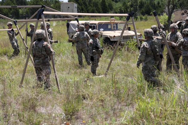 Oklahoma Army National Guard Soldiers from Headquarters Company, 700th Brigade Support Battalion, set up a tent as a part of the brigade support area at Glenwood Training Area in Midwest City, Oklahoma, July 13, 2024. The 700th BSB manages and supplies all the 45th Infantry Brigade Combat Team’s maneuver battalions and their forward support companies with all of their commodities, including food, water, fuel, ammunition, parts, and maintenance. (Oklahoma National Guard photo by Sgt. Connor McBride)