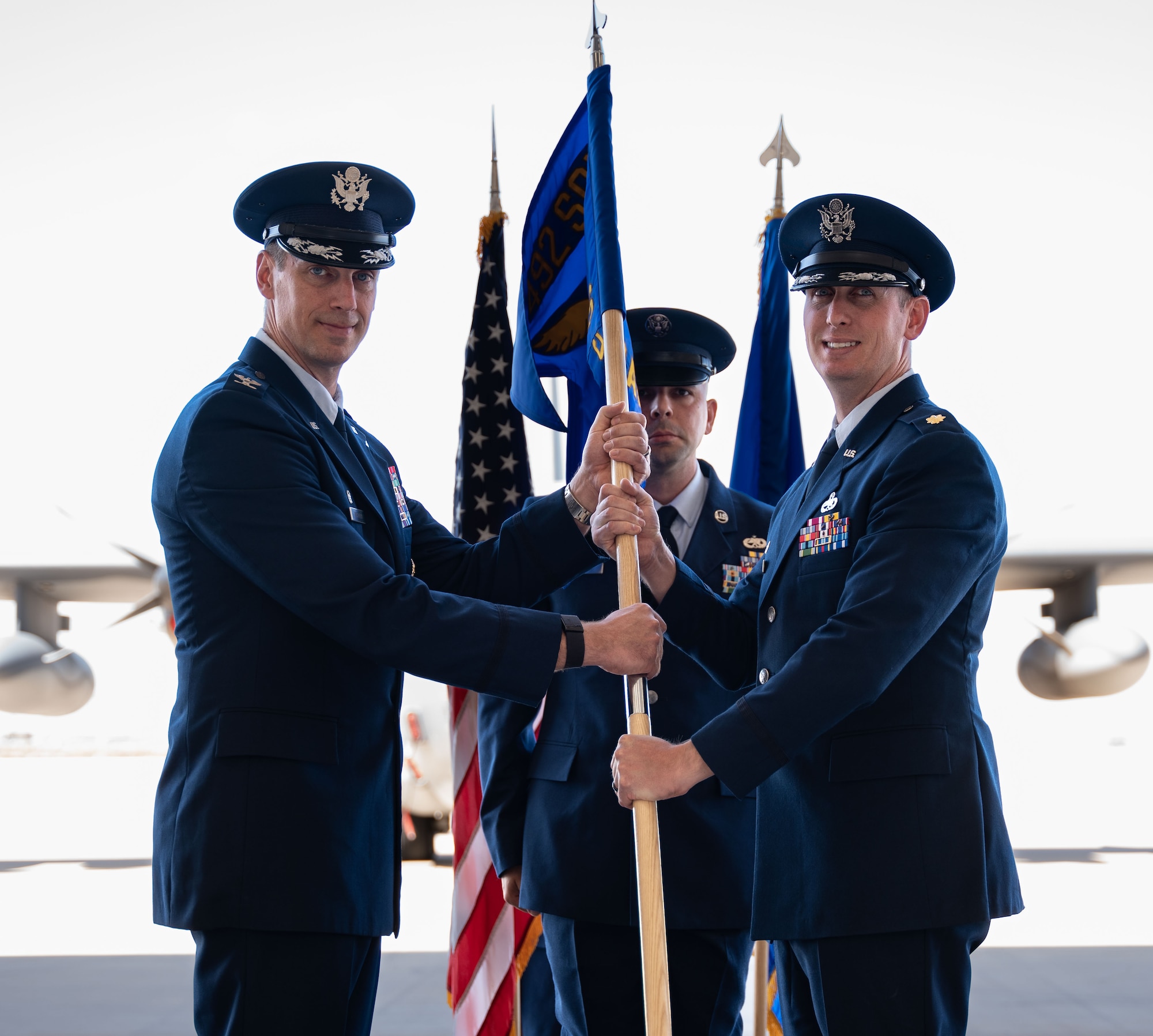 U.S. Air Force Col. Patrick Wnetrzak, 492nd Special Operations Wing commander, (left) presents the guidon to Maj. Patrick Britton, 6th Special Operations Aircraft Maintenance Squadron incoming commander, during an activation ceremony, July 9, 2024, at Cannon Air Force Base, New Mexico.
