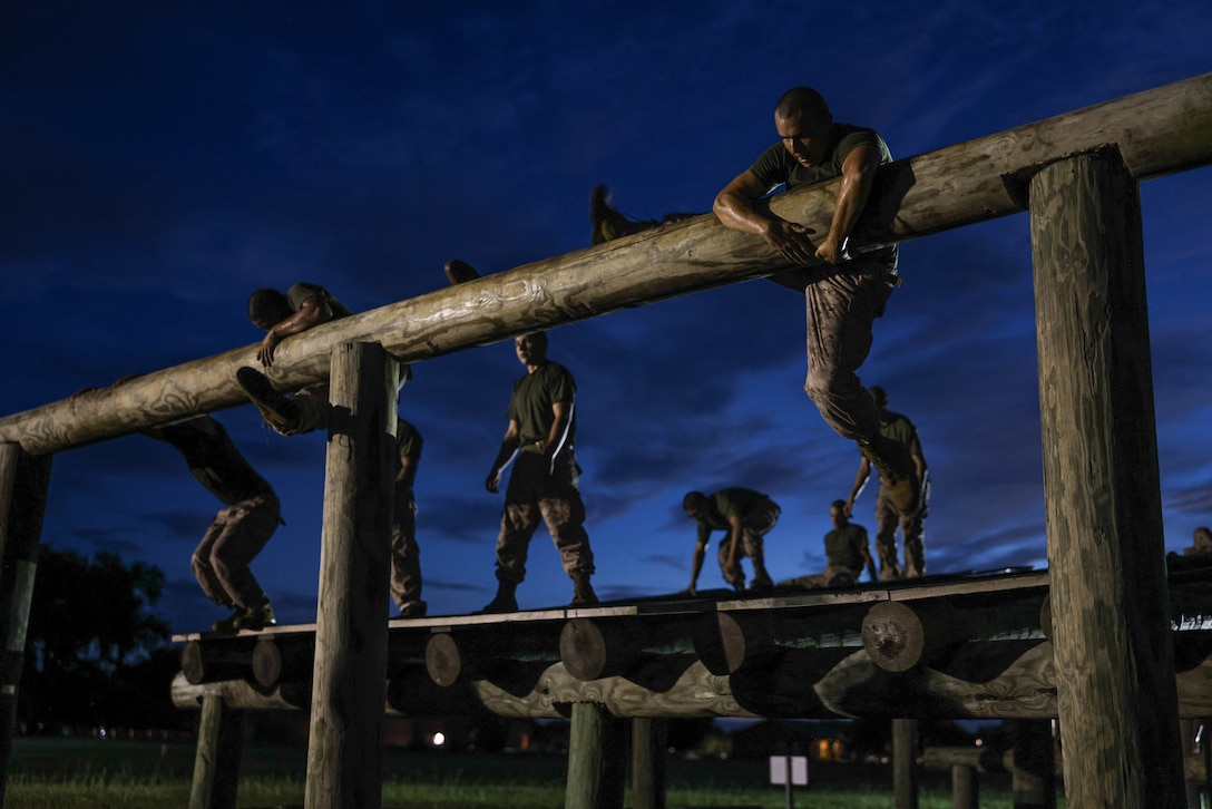 Recruits with Kilo Company, 3rd Recruit Training Battalion, conduct the Obstacle Course on Marine Corps Recruit Depot Parris Island, S.C., July 23, 2024. After demonstrations, recruits complete various physically and mentally challenging obstacles. (U.S. Marine Corps photo by Cpl. Ava Alegria)