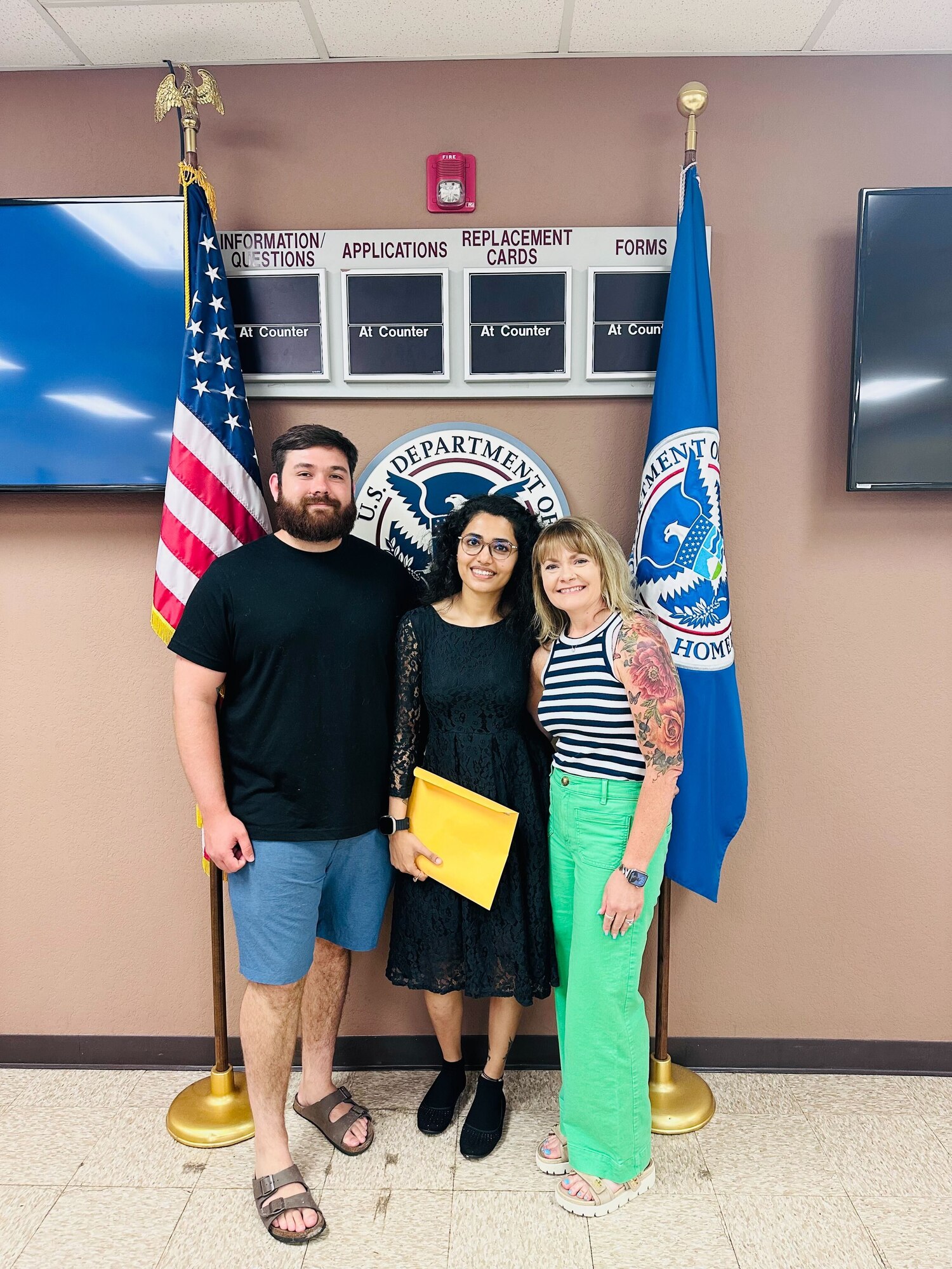 U.S. Air Force Airman 1st Class Benja Rayamajhi, 97th Force Support Squadron (FSS) career development technician, center, former Staff Sgt. Cody Cashdollar, previous 97th FSS customer support non-commissioned officer in charge, left, and Stephanie Sleeper, 97th FSS personnel system manager, right, pose for a photo in Oklahoma City, Oklahoma, June 25, 2024. Cashdollar and Sleeper went with Rayamajhi to support her during her citizenship ceremony. (Courtesy photo)