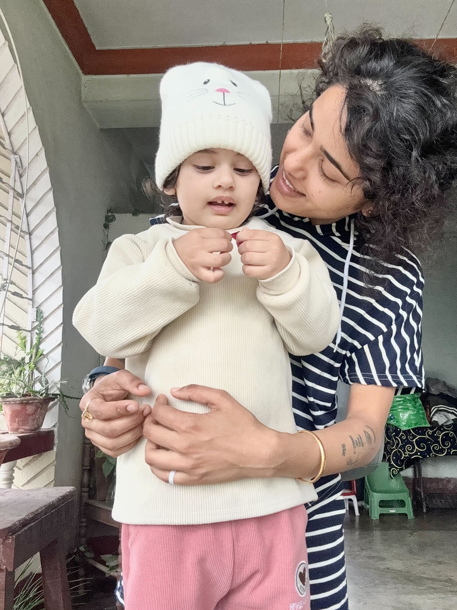 U.S. Air Force Airman 1st Class Benja Rayamajhi, 97th Force Support Squadron career development technician, holds her daughter in her home at Biratnagar, Nepal, March 17, 2024. Rayamajhi took time to visit her family for the first time in two years. (Courtesy photo)