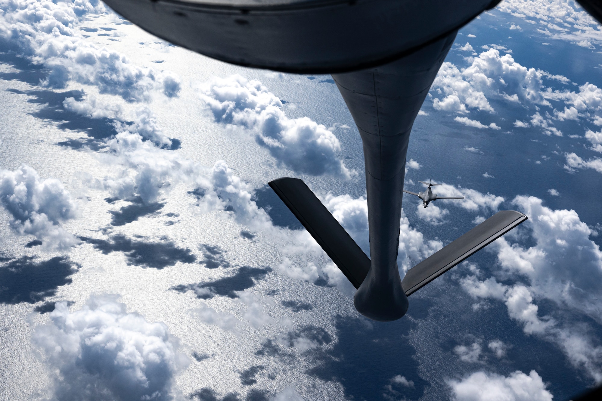 A B-1 receives fuel from a KC-135 Stratotanker while flying over the Pacific Ocean