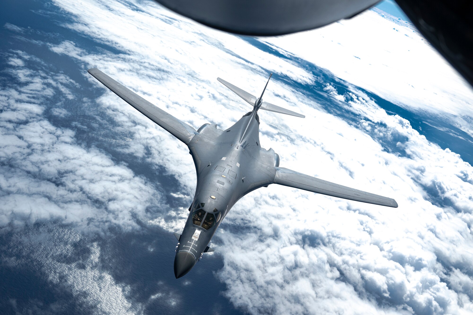 A B-1 receives fuel from a KC-135 Stratotanker while flying over the Pacific Ocean