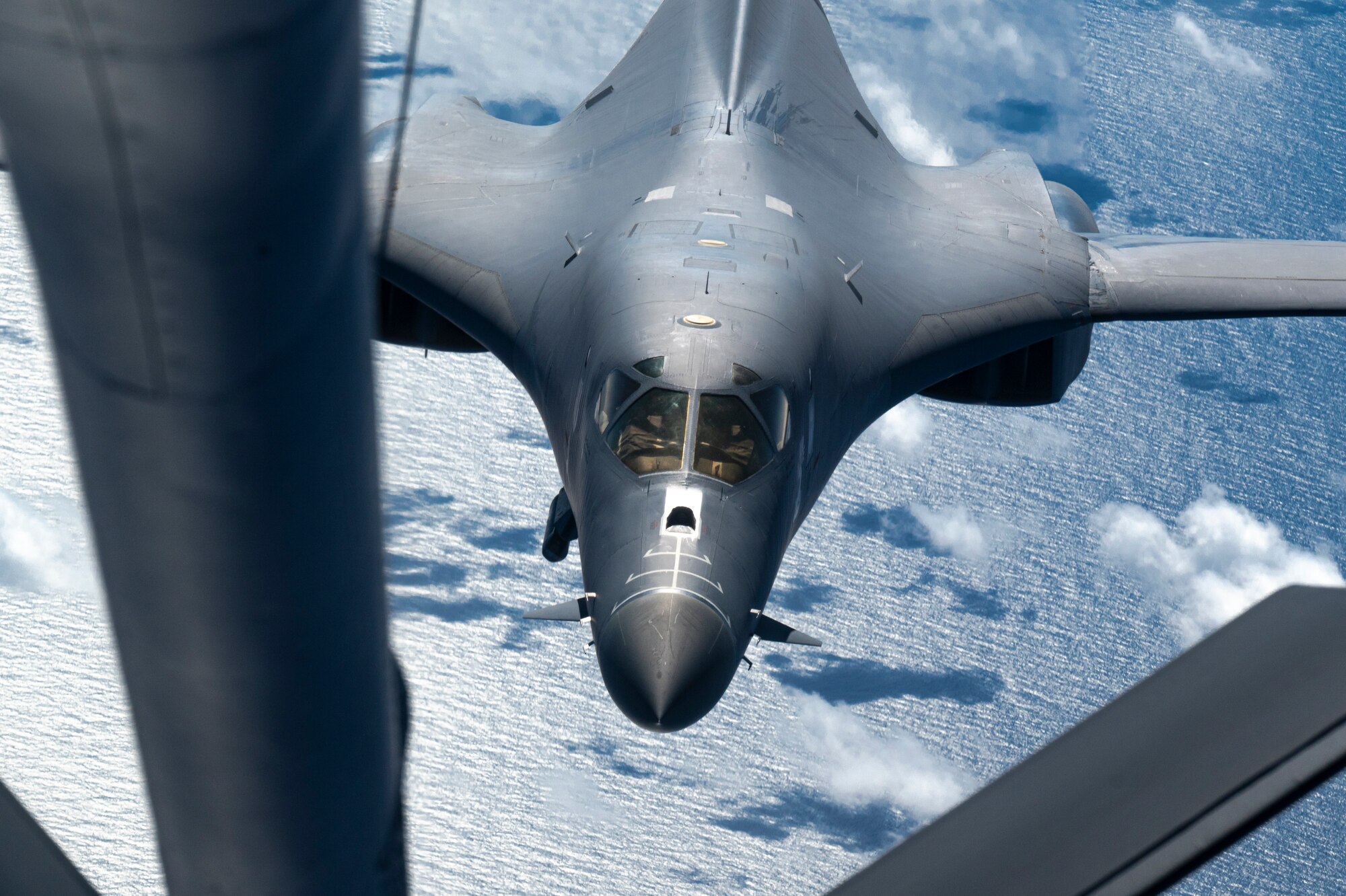 A B-1 receives fuel from a KC-135 Stratotanker while flying over the Pacific Ocean