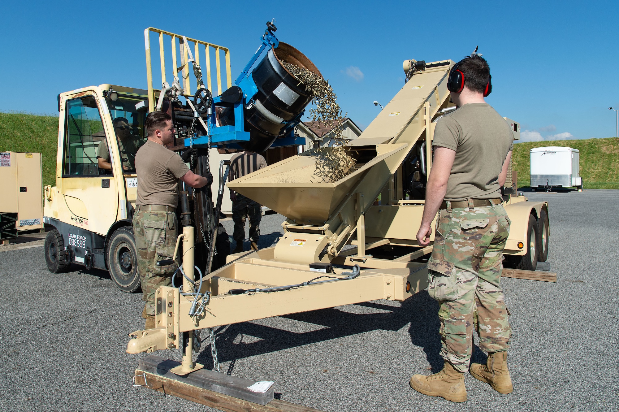 U.S. Airmen from the 436th Maintenance Squadron Munitions Flight, process spent small caliber brass munition cartridges using a deformer at Dover Air Force Base, Delaware, May 1, 2024. From its first use in February 2019, proceeds from brass sales have paid for the deformer and are now generating revenue for the base. (U.S. Air Force photo by Roland Balik)