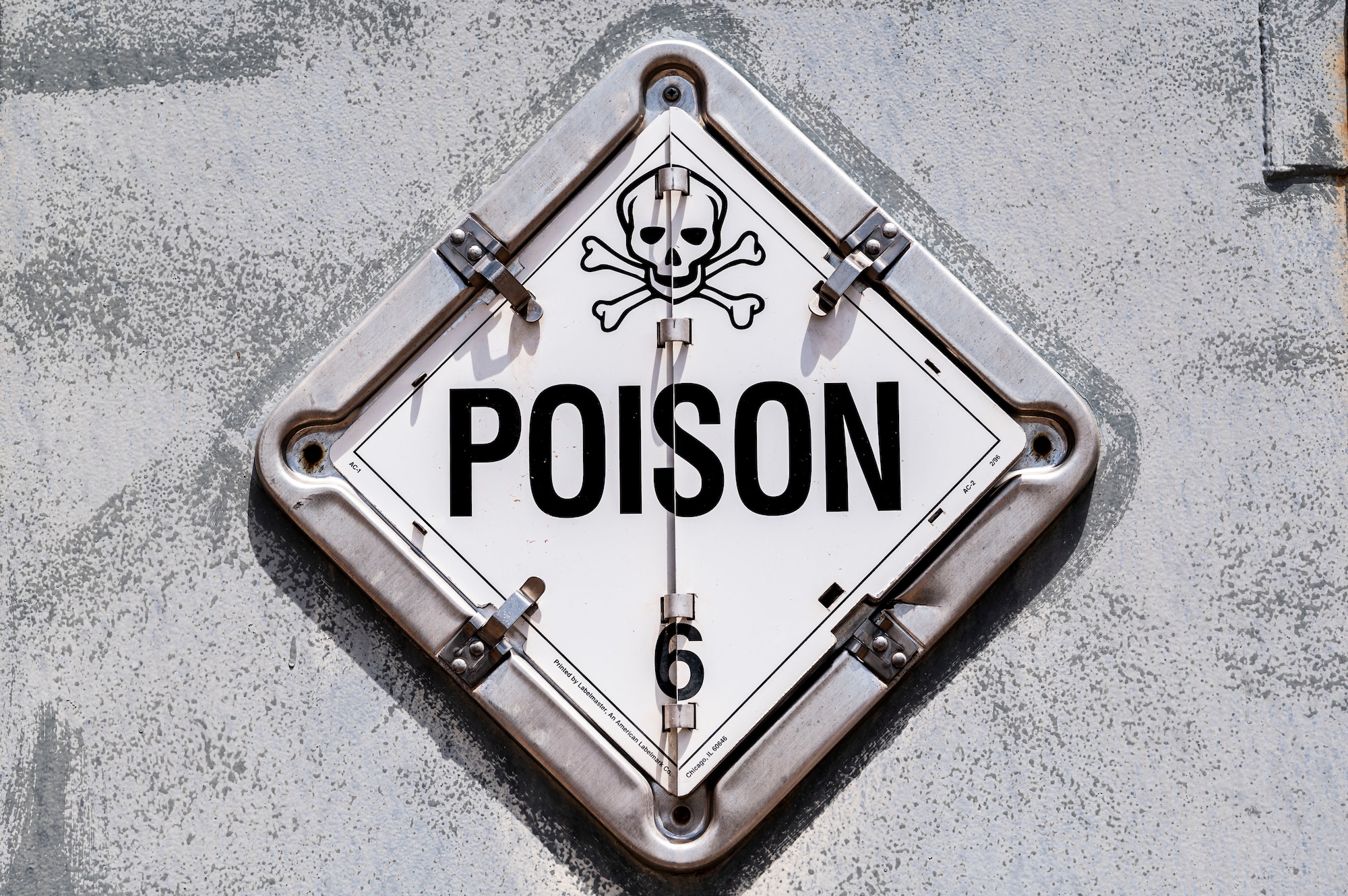 A poison sign is on display on the outside of a HAZMART storage container at Holloman Air Force Base, New Mexico, July 18, 2024. The HAZMART section is responsible for shipping and storing a wide range of hazardous materials, ensuring safe delivery to multiple organizations across the base. (U.S. Air Force photo by Senior Airman Isaiah Pedrazzini)