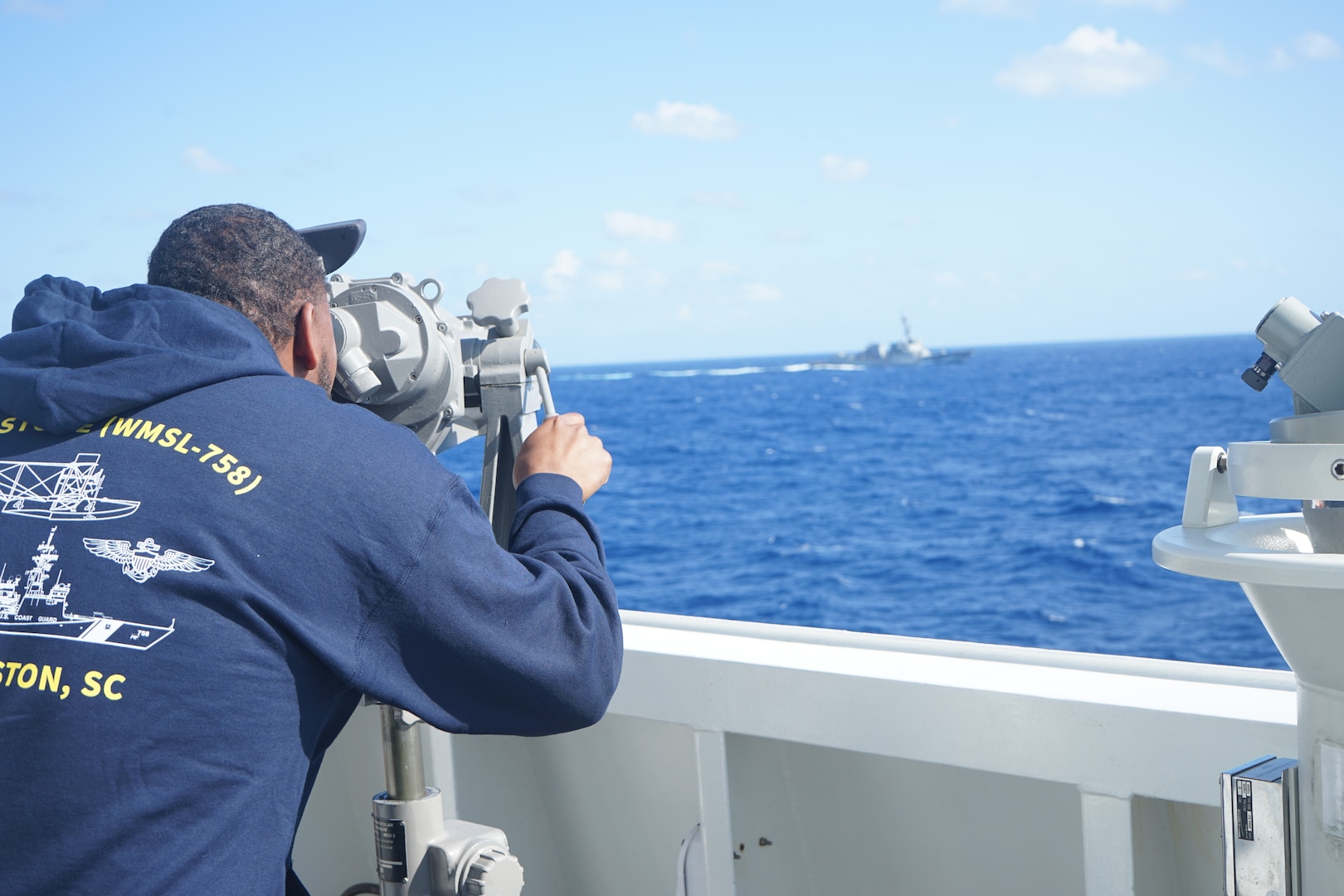 A Coast Guard Academy cadet aboard U.S. Coast Guard Cutter Stone (WMSL 758) observes Arleigh Burke-class destroyer USS Truxtun (DDG 103) while conducting maritime stability and security operations, June 3, 2024, in the Atlantic Ocean. (U.S Coast Guard photo by Ensign Alana Kickhoefer)