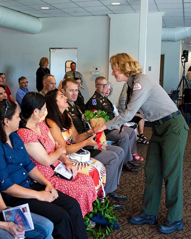 Malia Sutphin, park ranger at Cochiti Lake, presents Slavica Terzic, wife of outgoing Albuquerque District commander Lt. Col. Jerre Hansbrough, with a bouquet of red roses during the district’s change of command ceremony in Albuquerque, N.M., July 18, 2024. Red roses are traditionally given to the outgoing commander’s spouse to signify the bonds of loyalty and affection between the command and the commander’s spouse.