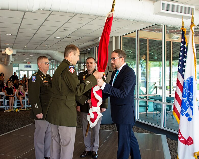 Jacob Pauley, Deputy District Engineer, USACE-Albuquerque District, passes the USACE flag to the outgoing district commander, Lt. Col. Jerre Hansbrough, during the change of command ceremony in Albuquerque, N.M., July 18, 2024.