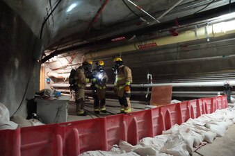 HALAWA, Hawaii (July 22, 2024) Members of the Federal Fire Department, Navy Region Hawaii simulate checking for levels of volatile organic compounds in the air at a containment wall during a joint spill drill exercise with Navy Closure Task Force - Red Hill (NCTF-RH) at the Red Hill Bulk Fuel Storage Facility (RHBFSF) in Halawa, Hawaii, July 22, 2024. The exercise tested the Navy’s emergency response capabilities and its ability to work with multiple agencies to respond to a spill consisting of a mixture of water and cleaning solution at the facility in preparation for pressure washing operations. Charged with the safe decommissioning of the facility, NCTF-RH was established by the Department of the Navy as a commitment to the community and the environment, and continues to engage with the people of Hawaii, regulatory agencies, and other stakeholders as it safely and deliberately decommissions the RHBFSF. (U.S. Navy photo by Mass Communication Specialist 1st Class Glenn Slaughter)