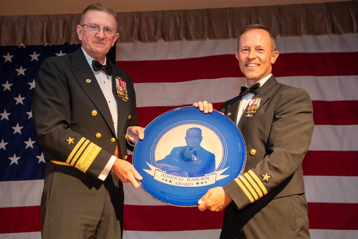 Vice Adm. Johnny Wolfe Jr., left, director of U.S. Navy Strategic Systems Programs, presents the fiscal year 2023 Admiral Raborn Award to Capt. Keith Fahlenkamp, Strategic Weapons Facility Pacific commanding officer, at a gala held at Naval Base Kitsap-Bangor Plaza in Silverdale, Washington July 20, 2024. SWFPAC was selected for the award for their dedication to strategic planning, unwavering rigor in program execution, innovation, and technical competence. SWFPAC is a naval shore facility dedicated to assembling and deploying TRIDENT missiles on Fleet Ballistic Missile submarines while providing safe, secure, credible and affordable sea-based missile systems. (U.S. Navy photo by Mass Communication Specialist 2nd Class Victoria Galbraith/Released)
