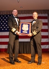 Vice Adm. Johnny Wolfe Jr., left, director of U.S. Navy Strategic Systems Programs, presents the fiscal year 2023 Chief of Naval Operations Shore Safety Award to Capt. Keith Fahlenkamp, Strategic Weapons Facility Pacific commanding officer, at a gala held at Naval Base Kitsap-Bangor Plaza in Silverdale, Washington July 20, 2024. SWFPAC was selected for the award for its significant contribution to Navy safety and occupational health for small industrial activity. SWFPAC is a naval shore facility dedicated to assembling and deploying TRIDENT missiles on Fleet Ballistic Missile submarines while providing safe, secure, credible and affordable sea-based missile systems..  (U.S. Navy photo by Mass Communication Specialist 2nd Class Victoria Galbraith/Released)