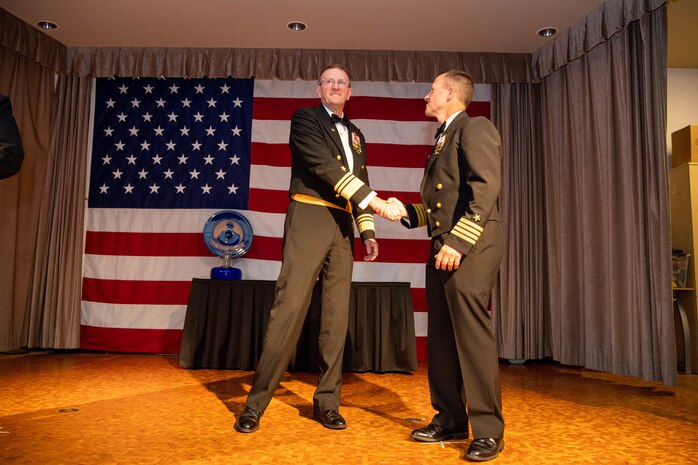 Vice Adm. Johnny Wolfe Jr., left, director of U.S. Navy Strategic Systems Programs and Capt. Keith Fahlenkamp, Strategic Weapons Facility Pacific commanding officer, shake hands at a gala held at Naval Base Kitsap-Bangor Plaza in Silverdale, Washington July 20, 2024.  During the gala, Vice Adm. Wolfe presented two awards to Capt. Keith Fahlenkamp, SWFPAC commanding officer, including the fiscal year 2023 Admiral Raborn Award and the fiscal year 2023 Chief of Naval Operations Shore Safety Award. SWFPAC is a naval shore facility dedicated to assembling and deploying TRIDENT missiles on Fleet Ballistic Missile submarines while providing safe, secure, credible and affordable sea-based missile systems. (U.S. Navy photo by Mass Communication Specialist 2nd Class Victoria Galbraith/Released)