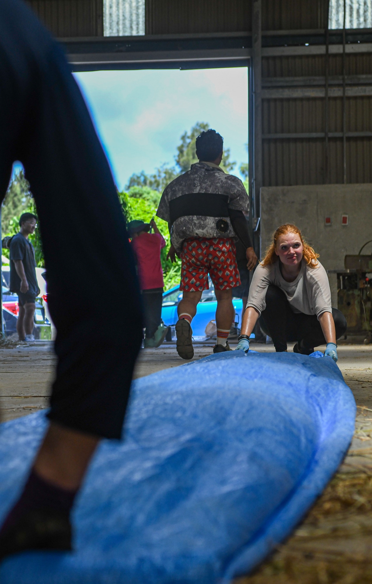 Military members and Okinawa locals clean up after finishing a volunteer event.