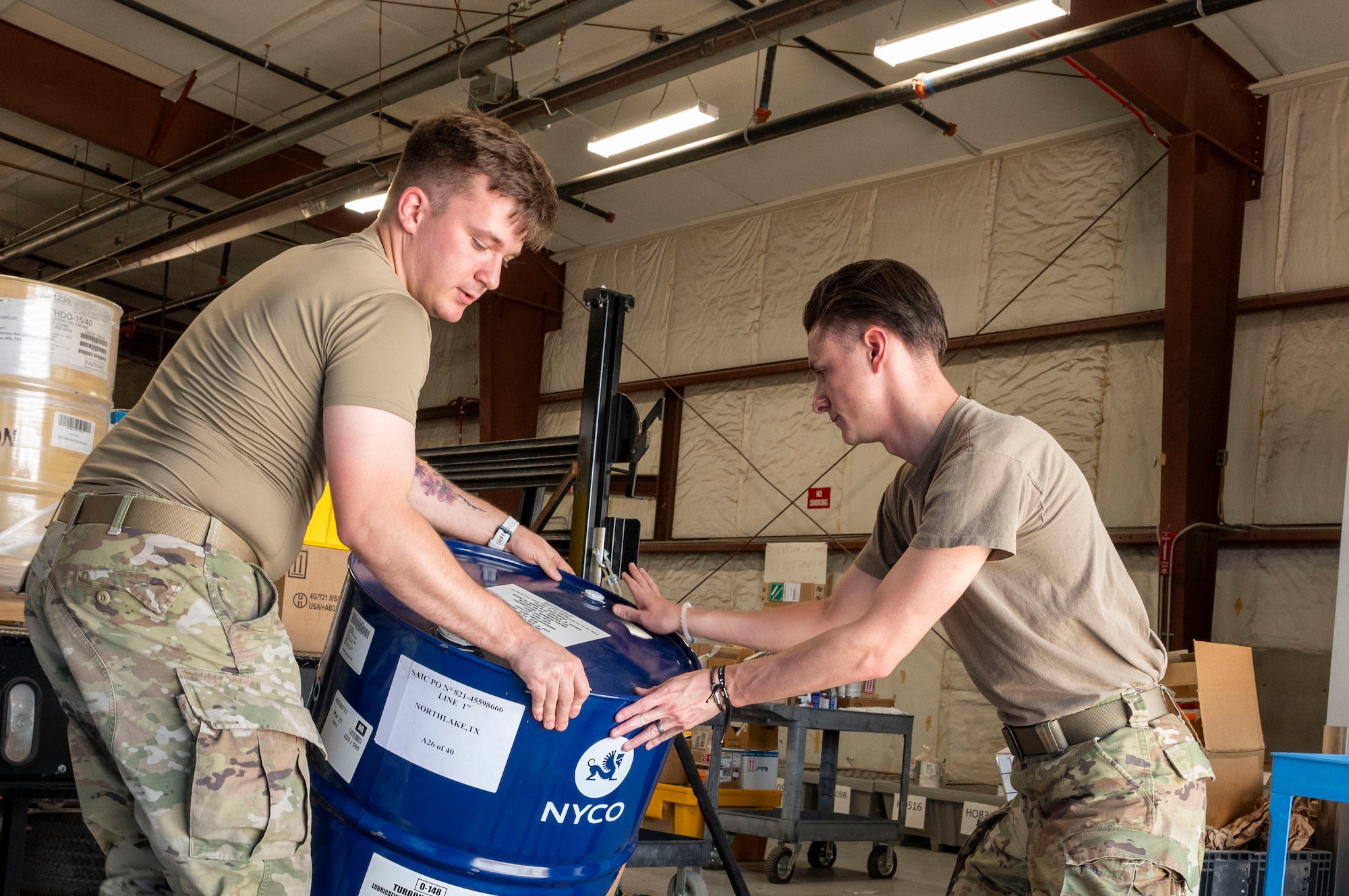 U.S. Air Force Airman Logan Dombrowski, 49th Logistics Readiness Squadron HAZMART journeyman, right, and U.S. Air Force Senior Airman Christian Goodwin, 49th LRS HAZMART journeyman, unload a barrel at Holloman Air Force Base, New Mexico, July 18, 2024. The HAZMART section is responsible for shipping and storing a wide range of hazardous materials, ensuring safe delivery to multiple organizations across the base. (U.S. Air Force photo by Senior Airman Isaiah Pedrazzini)
