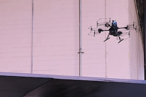 A drone flys above a B-52 Stratofortress and gathers information about potential damage done to the aircraft