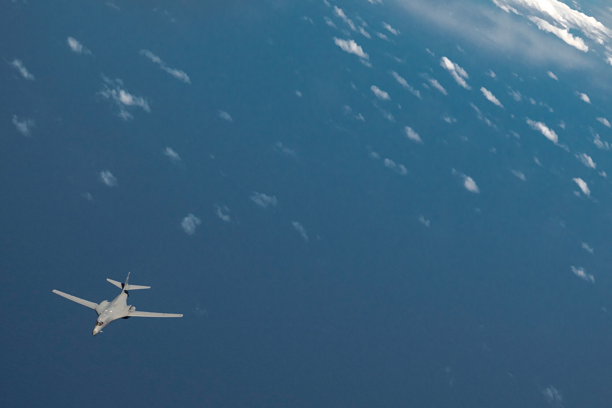 A B-1 receives fuel from a KC-135 Stratotanker while flying over the Pacific Ocean