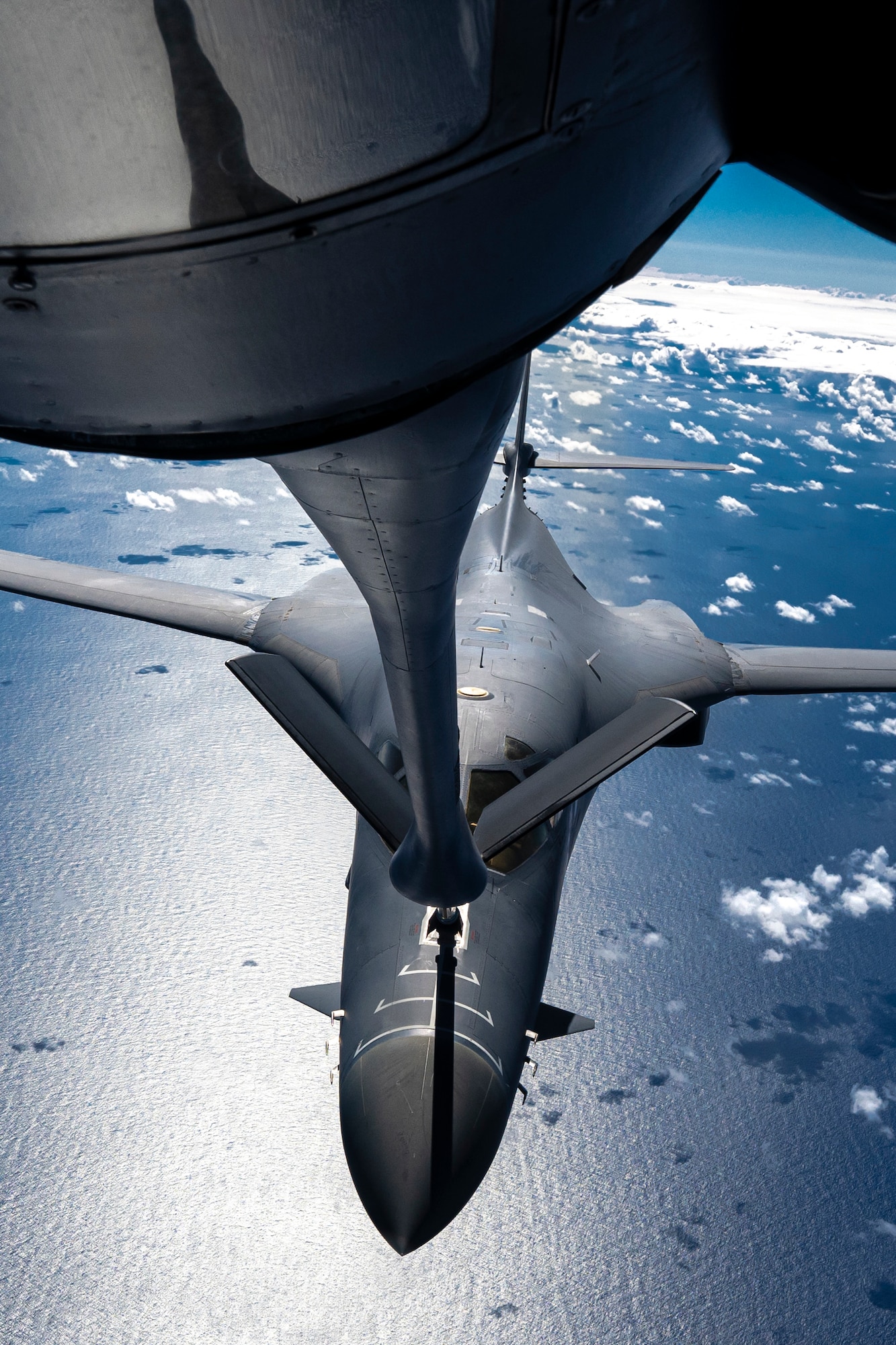 A B-1 receives fuel from a KC-135 Stratotanker while flying over the Pacific Ocean