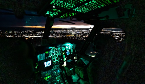 An aircraft flying over a city at night.