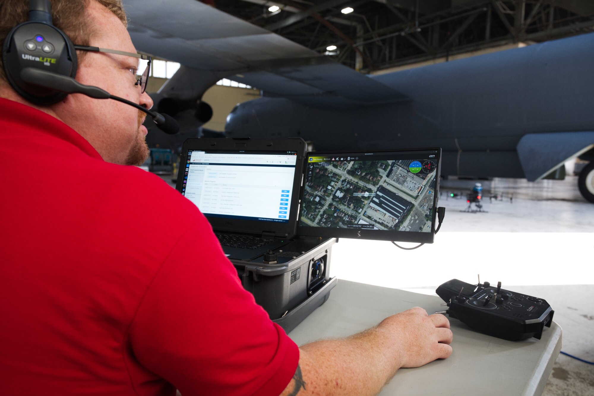 A Near Earth Autonomy employee launches a drone at Barksdale Air Force Base
