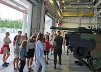 Polish school children check out an M1A2 Abrams main battle tank at the Army Prepositioned Stocks-2 worksite in Powidz, Poland, July 23. When asked by their counterparts at the Polish air force’s 33rd Air Base if the school children could visit the new APS-2 worksite, the Army Field Support Battalion-Poland commander agreed. (Capt. James Bath)